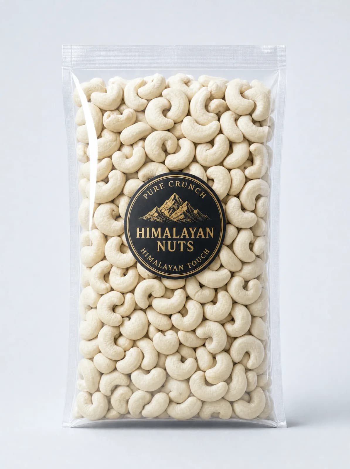 A sealed clear bag of whole raw cashews with a round black and gold Himalayan Nuts seal
