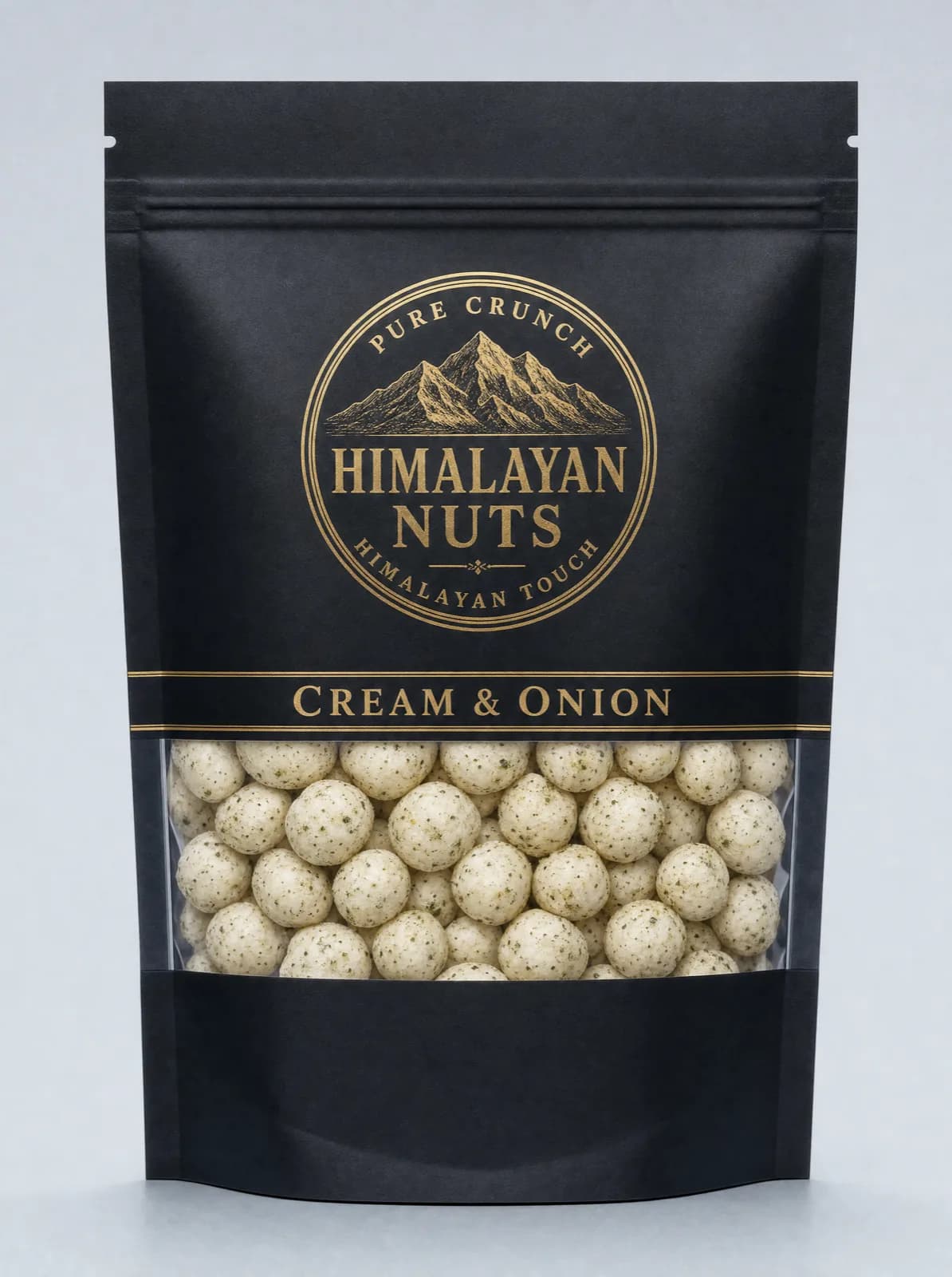 Matte black Himalayan Nuts pouch, gold seal and a Cream & Onion band, with a clear window showing speckled seasoned fox nuts