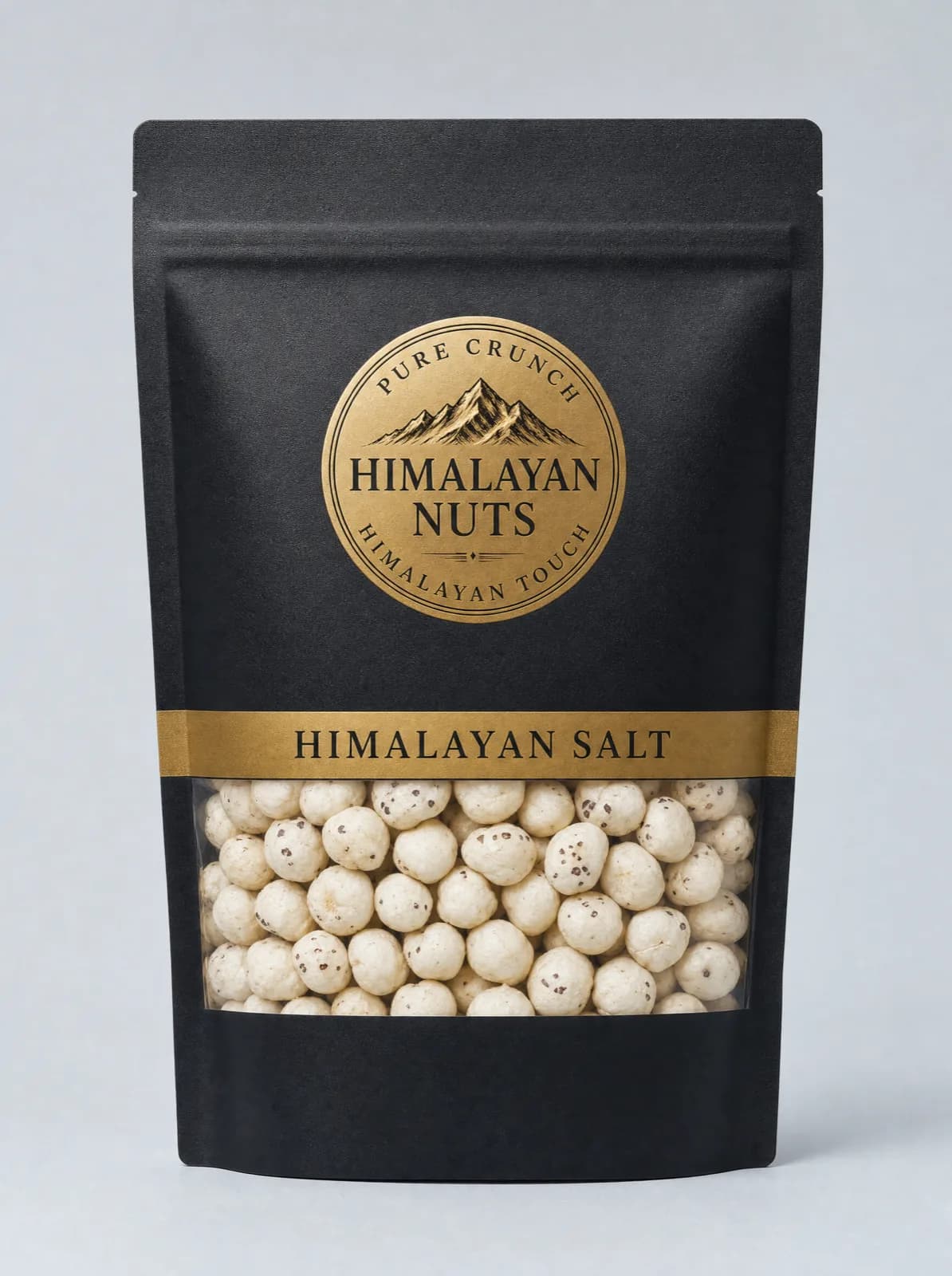Matte black Himalayan Nuts pouch, gold seal and a Himalayan Salt band, with a clear window showing pale roasted fox nuts